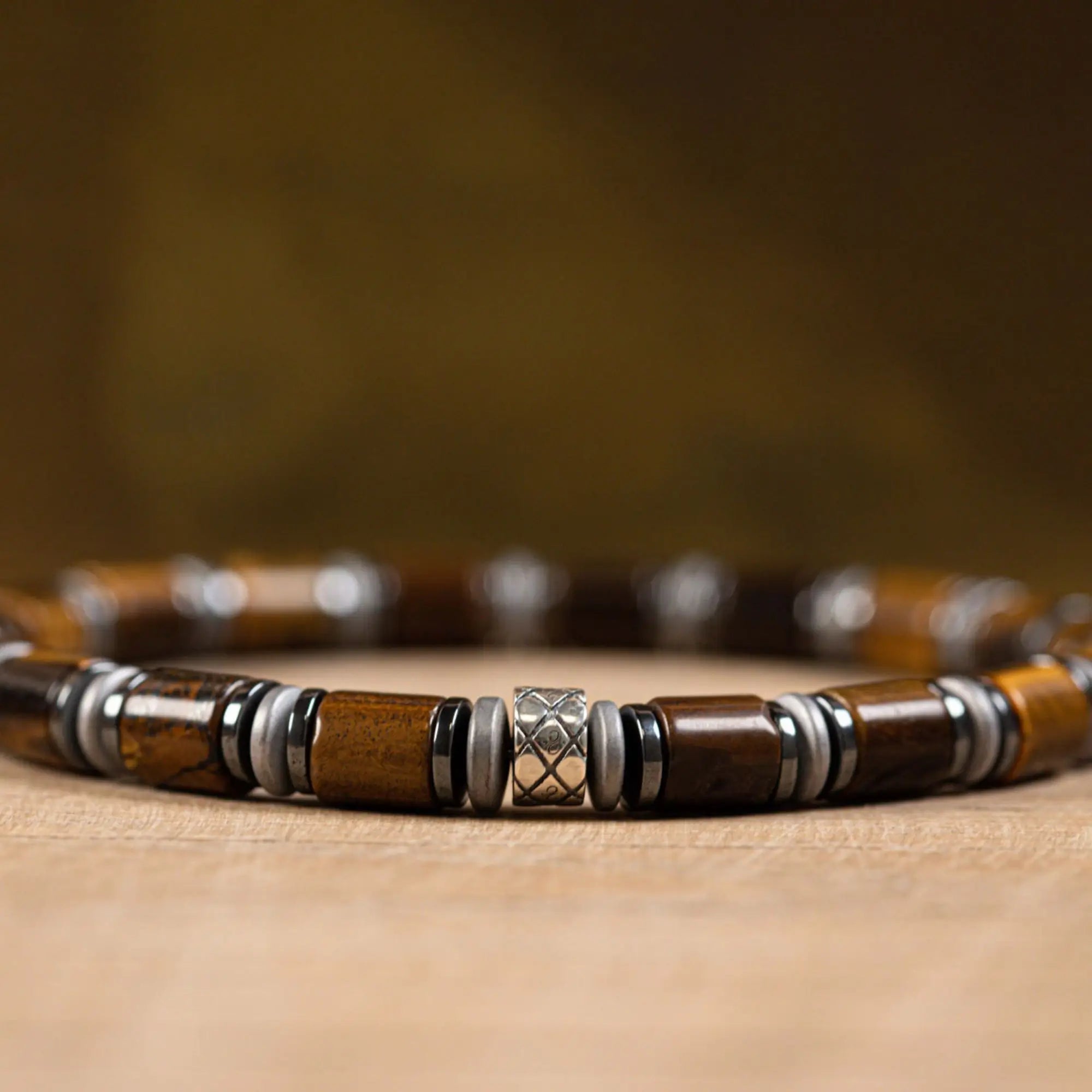 Tiger eye bracelet for men on natural wood surface, lifestyle view. 6mm Abacus design. Aurum Brothers.
