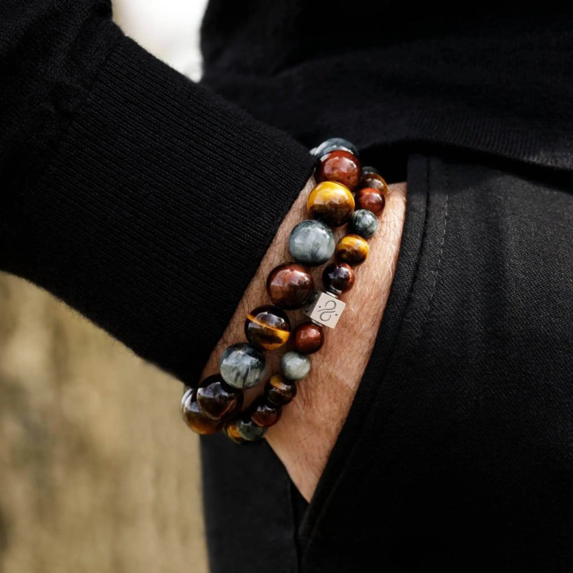 Tiger eye bracelet for men worn on wrist. 8mm Brown, Red, and Grey Eagle Eye beads. Aurum Brothers.