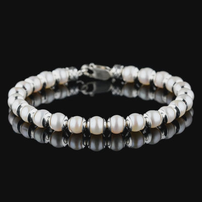 Product video of White Pearl Bracelet II (6.5mm), showing the white pearls, silver spacers and clasp.