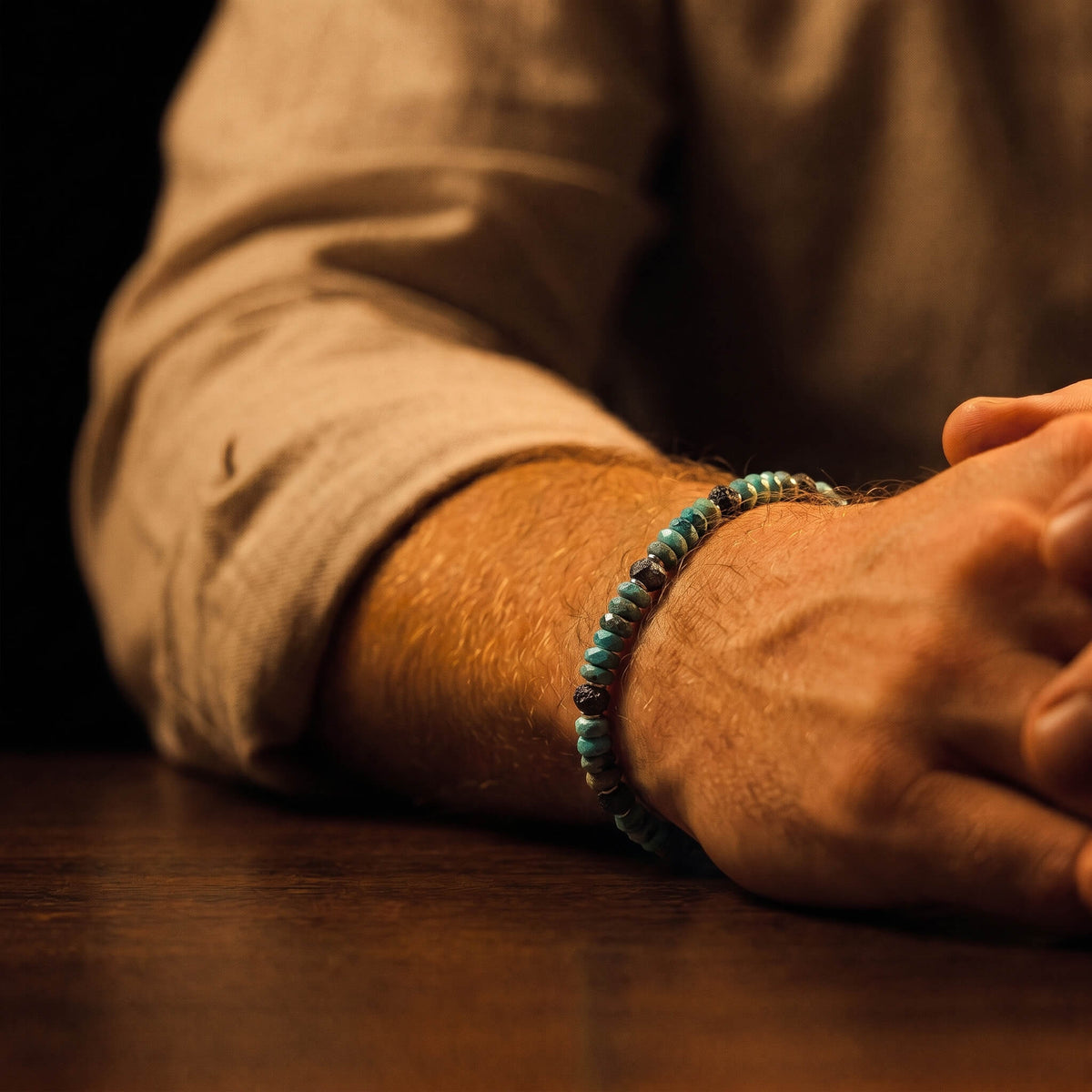 Raw Black Diamond–Turquoise — Bracelet on the wrist beside a tan sleeve